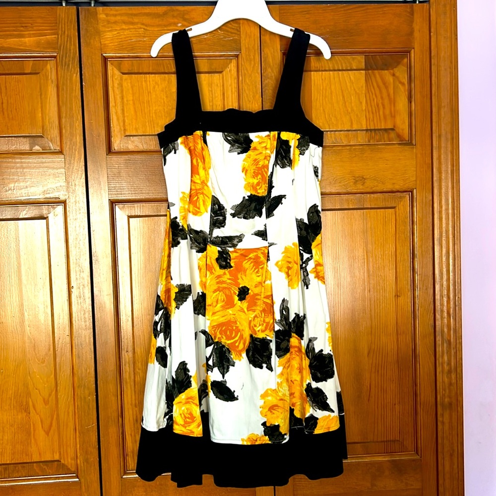 White dress with yellow and black flower pattern size 12 above the knee